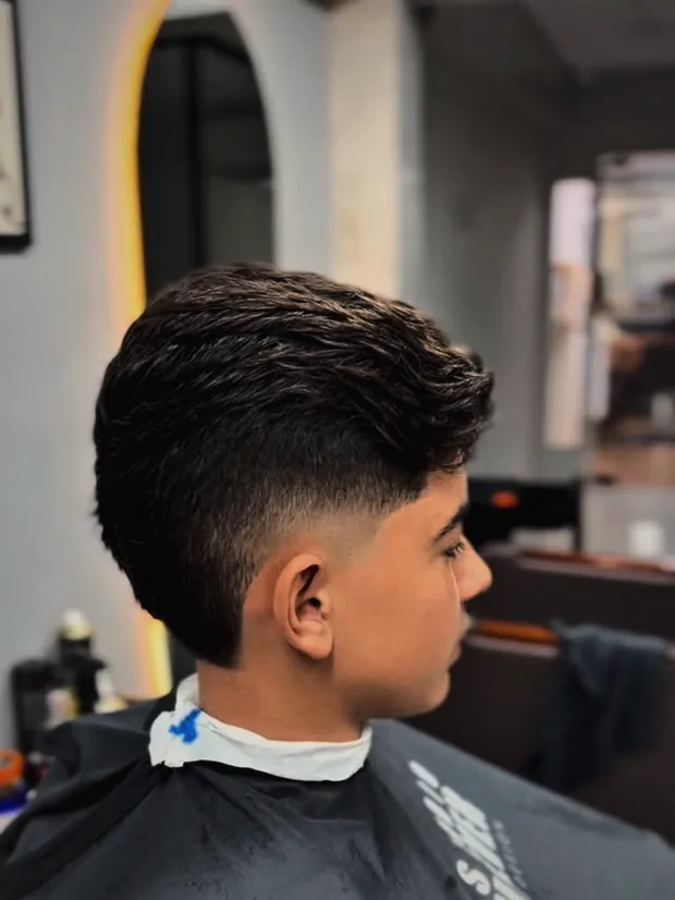 Perfil de cliente com corte degradê finalizado no Studio Wolver